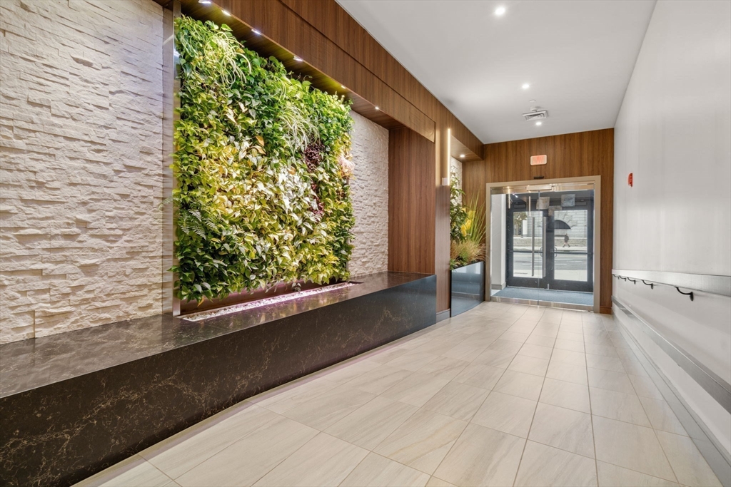 121-127 Portland Street, Unit 202 Boston, MA 02114 - Photo 19 of 25 a view of a large room with large windows