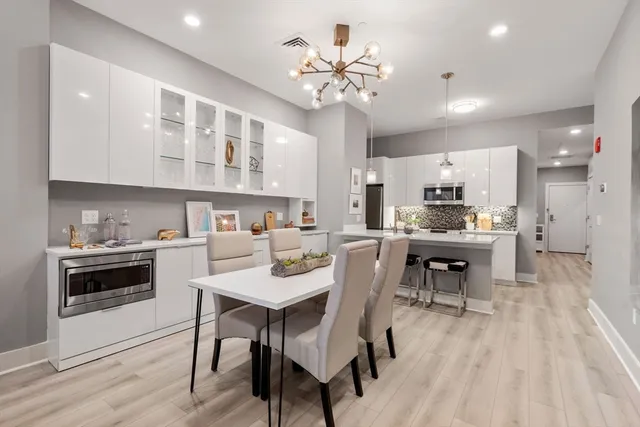 a kitchen with a table chairs stove and cabinets