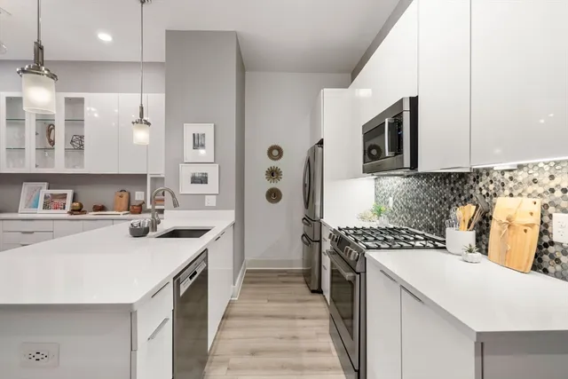 a kitchen with a sink stove and cabinets