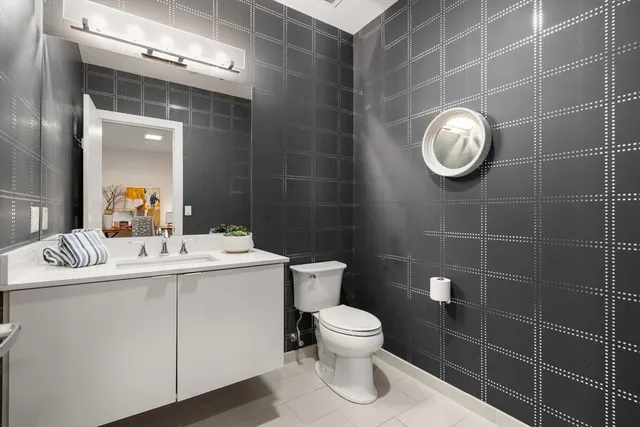 a bathroom with a toilet a sink and mirror