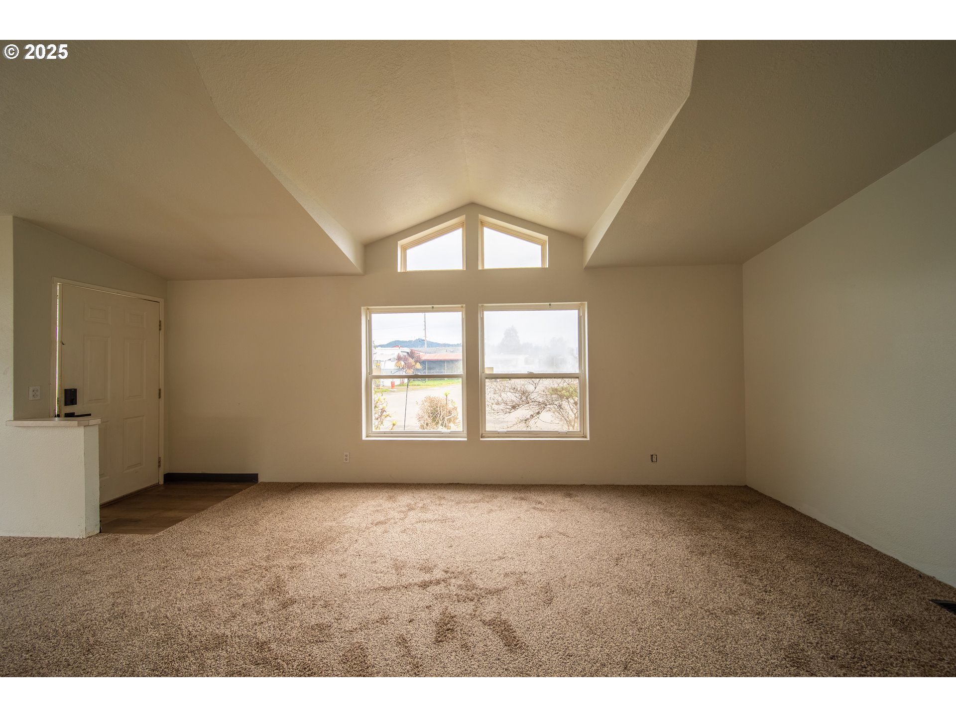 1413 Hawthorne Avenue Reedsport, OR 97467 - Photo 5 of 32 a view of an empty room with a window