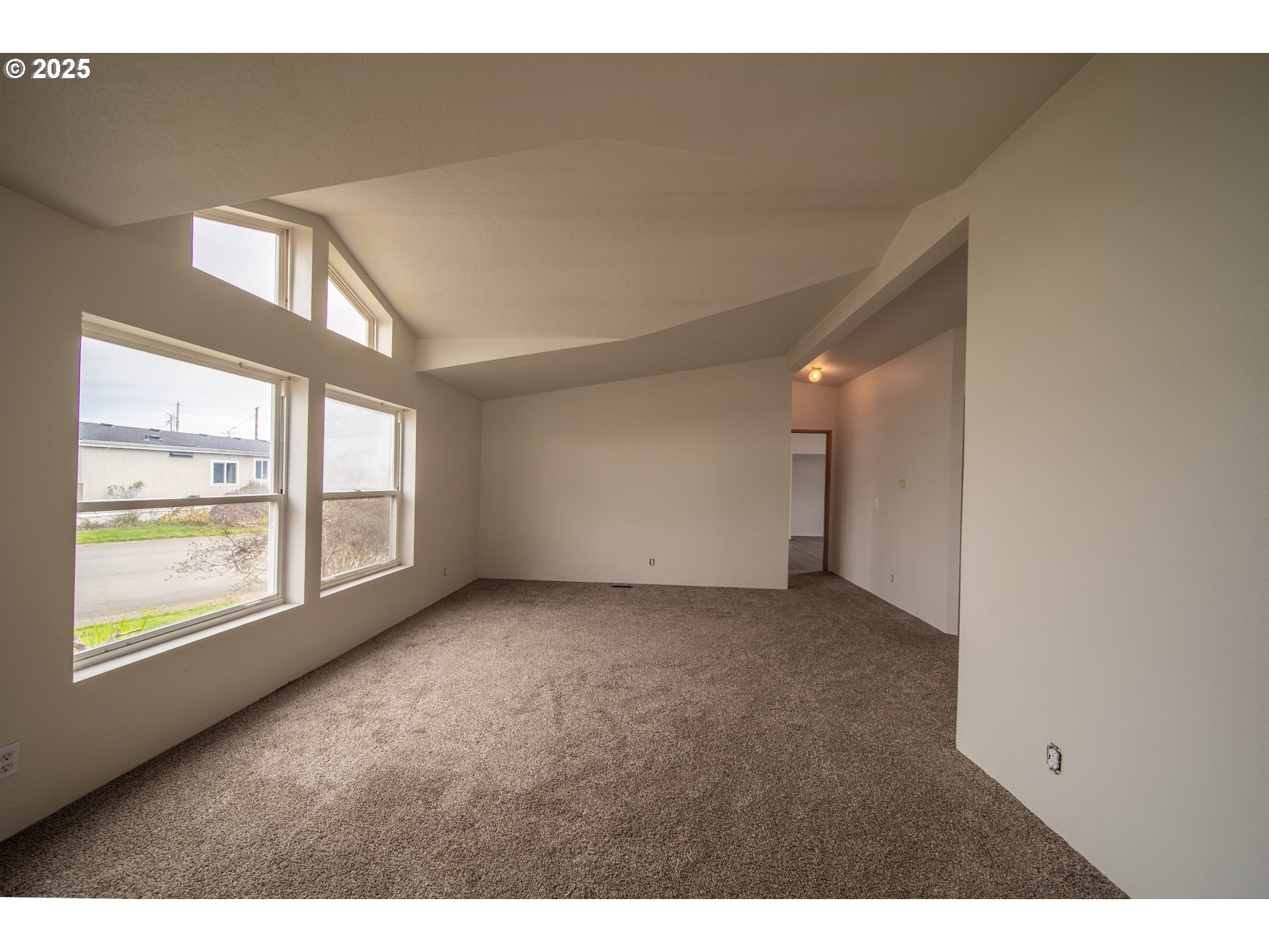 1413 Hawthorne Avenue Reedsport, OR 97467 - Photo 6 of 32 a view of an empty room with a window