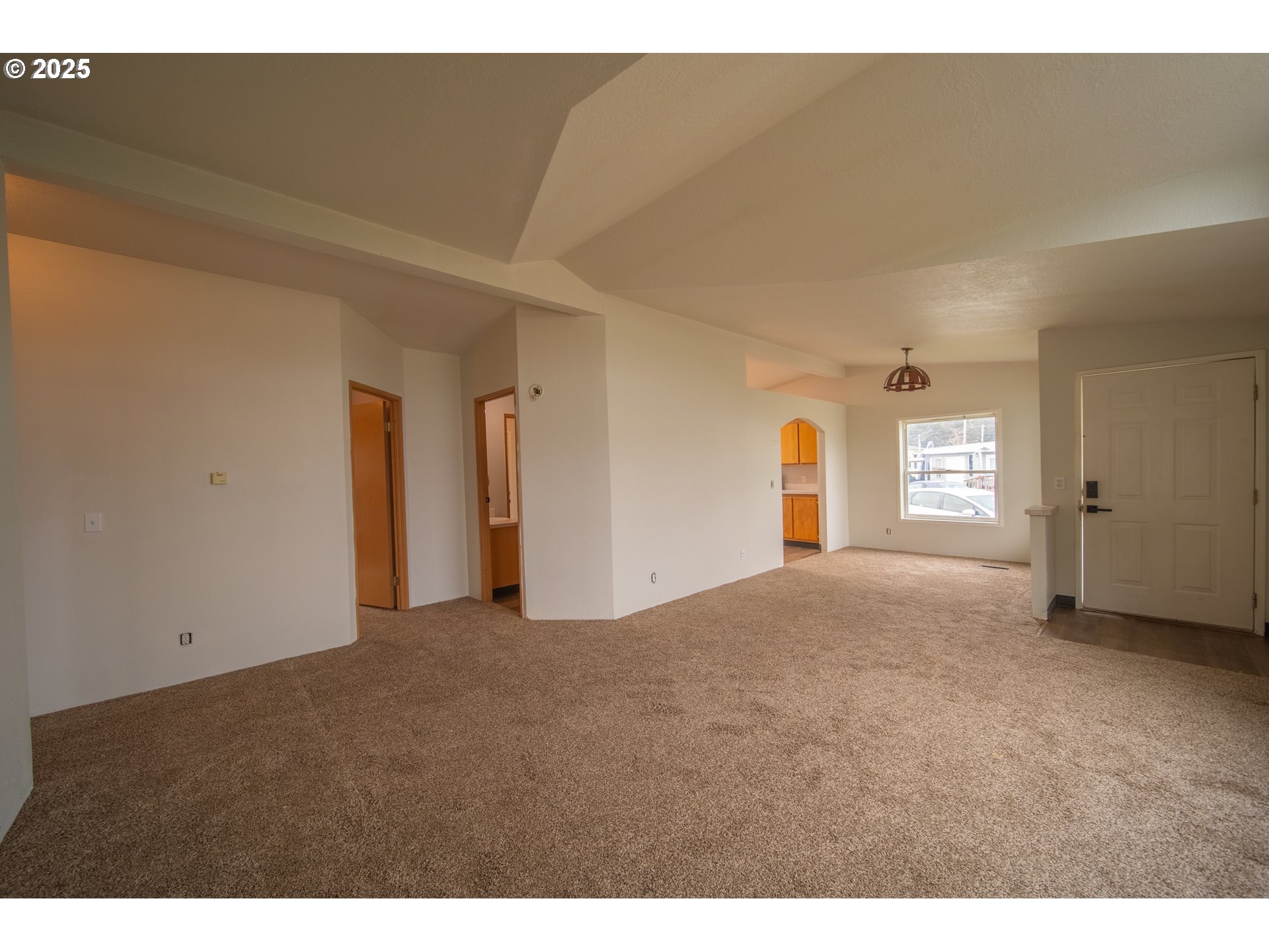 1413 Hawthorne Avenue Reedsport, OR 97467 - Photo 7 of 32 a view of a big room with windows and fireplace