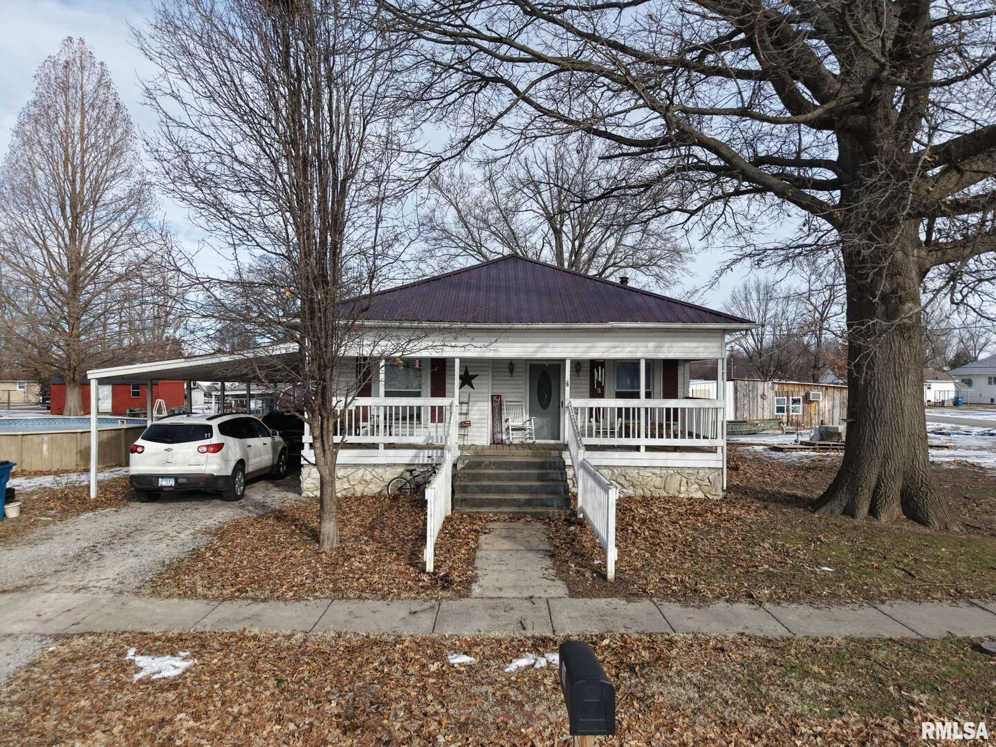 a front view of a house with a yard and balcony