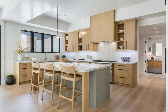 a kitchen with a sink stove and white cabinets