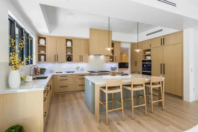 a view of a kitchen center island with stainless steel appliances granite countertop furniture and a kitchen counter top