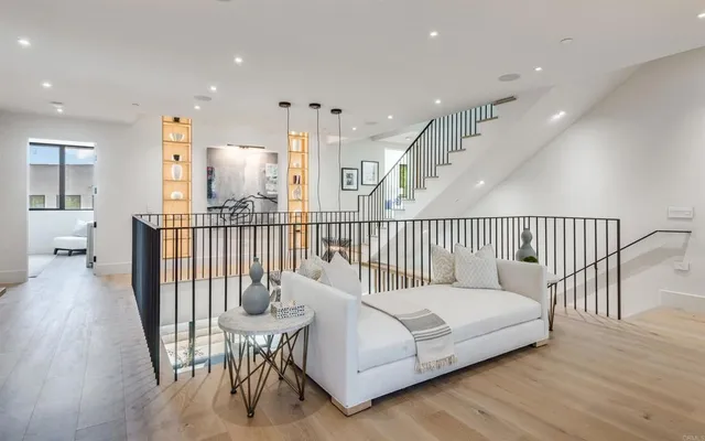 a living room with furniture a rug and a large window