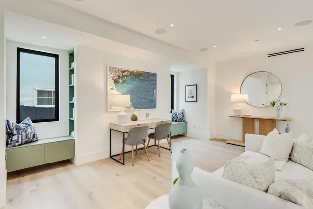 a bedroom with a bed and large window