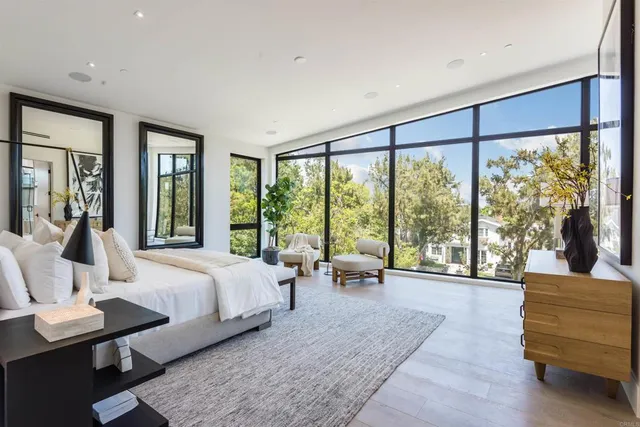 a spacious bedroom with a bed a couch and dresser