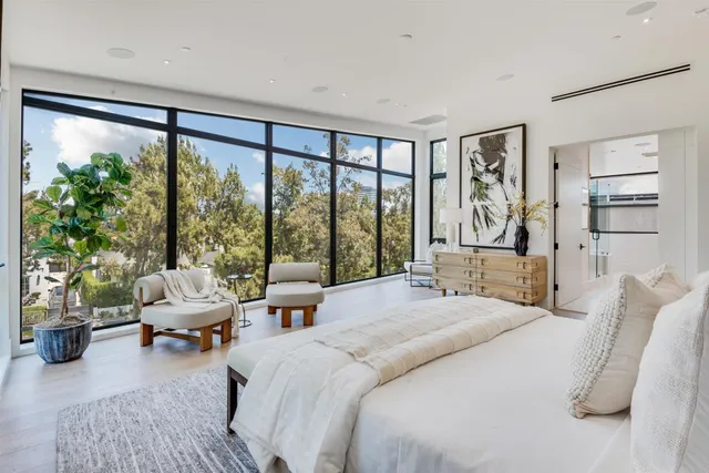 a bedroom with a bed and large window