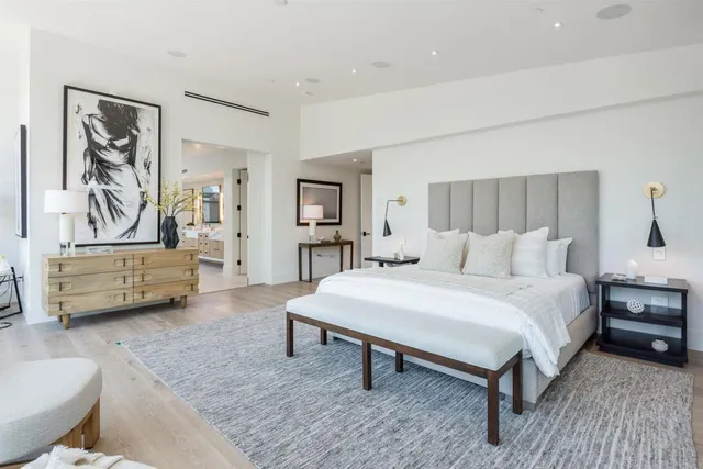 a bathroom with double vanity sink a two mirror a window a bathtub and vanity