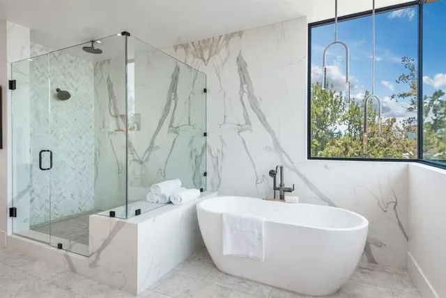 a bedroom with a bed and a large window