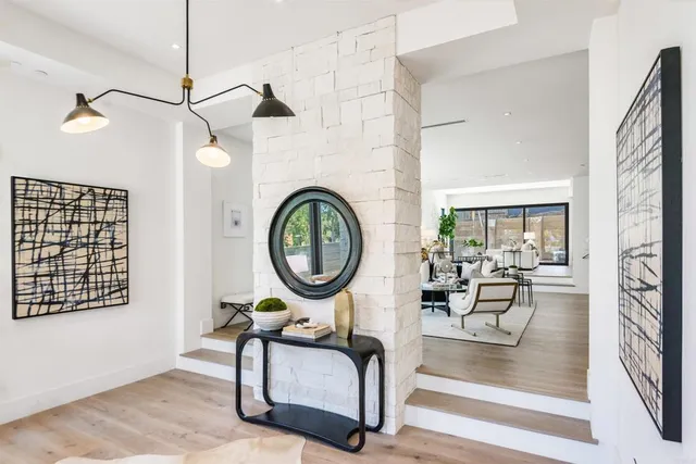 a living room with furniture a rug and white walls