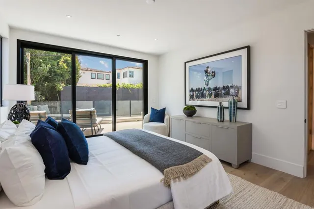 a bedroom with a large bed and a large window