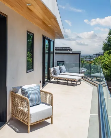 a bedroom with a bed and glass window