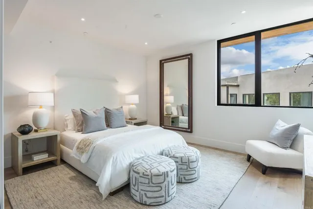 a living room with furniture and a large mirror