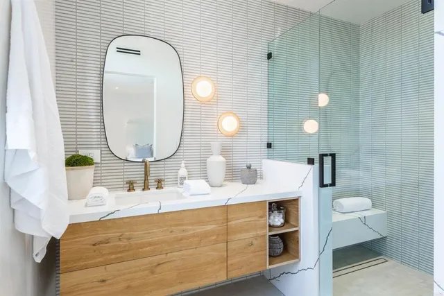 a bathroom with a sink a toilet and shower