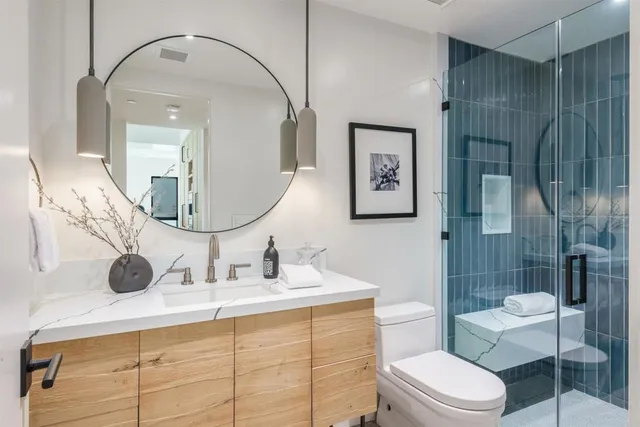 a roof deck with couches and potted plants