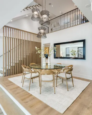 a dining room with wooden floor and a rug