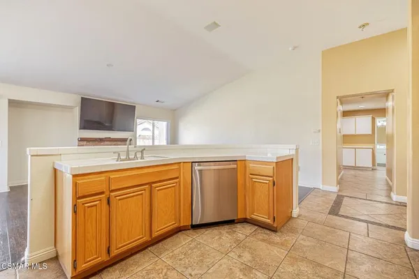 a kitchen with a sink appliances and cabinets