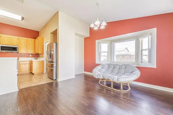 a dining room with furniture a chandelier and wooden floor