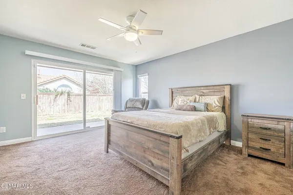 a bedroom with a bed couch and window