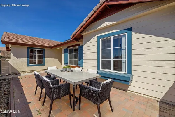 a table and chairs in front of a house