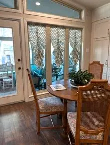 a view of a room with a table and chairs