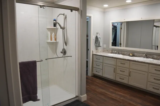 a bathroom with a double vanity sink a and mirror