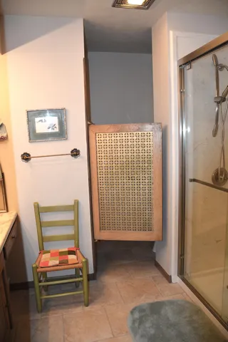 a bathroom with a shower and a sink
