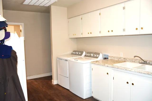 a bathroom with a granite countertop toilet and a shower