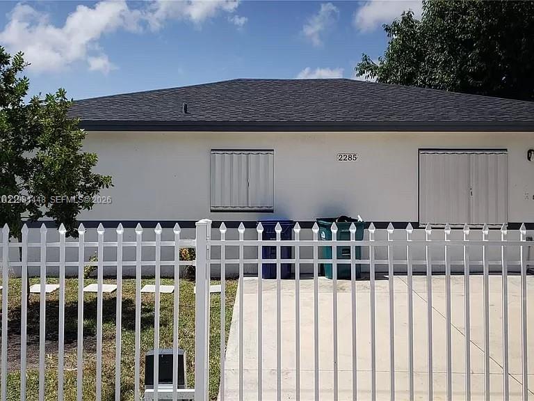 2285 Northwest 91st Street Miami, FL 33147 - Photo 1 of 9 a view of a house with a wooden fence