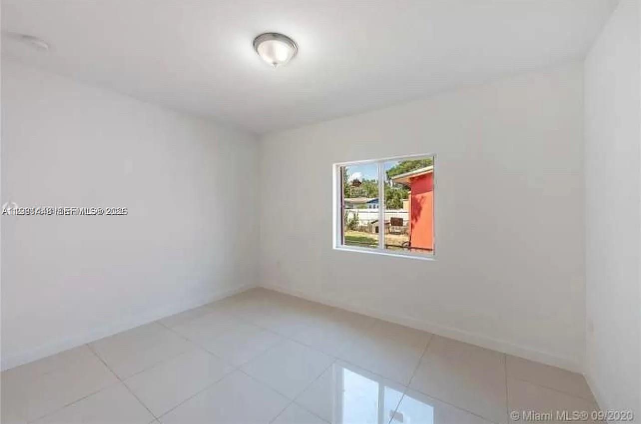 2285 Northwest 91st Street Miami, FL 33147 - Photo 6 of 9 an empty room with windows