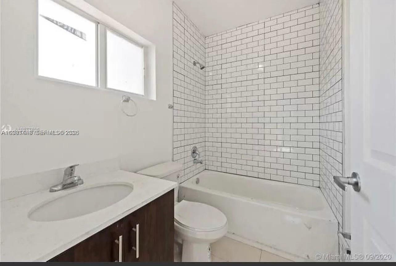 2285 Northwest 91st Street Miami, FL 33147 - Photo 7 of 9 a bathroom with a sink toilet and shower