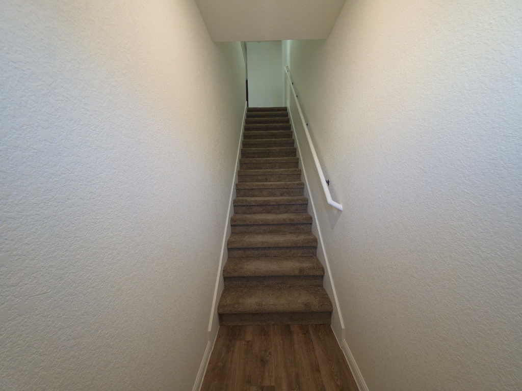 2002 West 2nd Street, Unit 1202 Taylor, TX 76574 - Photo 4 of 15 Secured indoor stairs lead to second floor unit
