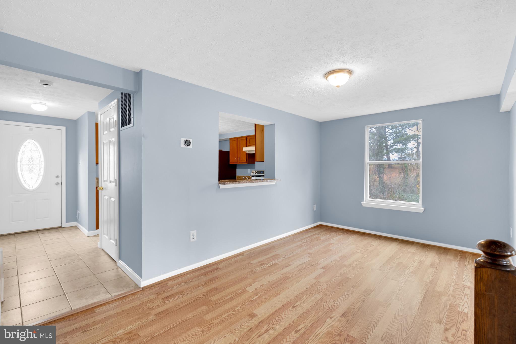 7600 Mandan Road Greenbelt, MD 20770 - Photo 18 of 42 a view of an empty room with window and wooden floor