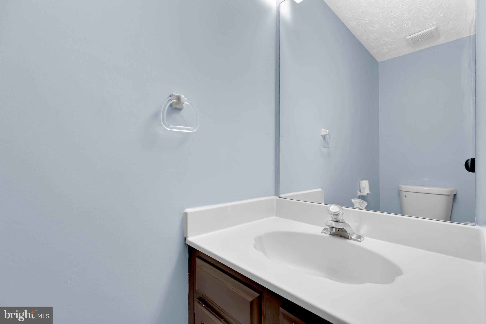 7600 Mandan Road Greenbelt, MD 20770 - Photo 20 of 42 a bathroom with a sink and a mirror