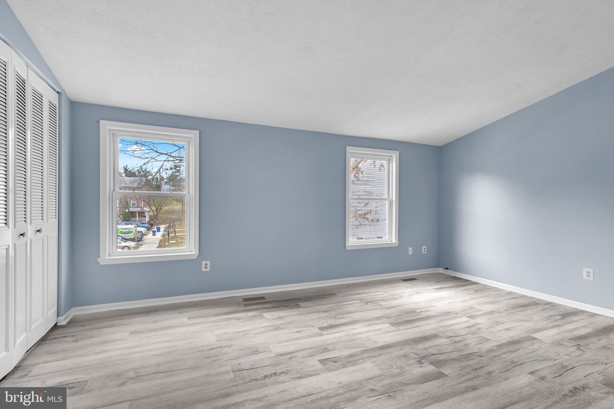 7600 Mandan Road Greenbelt, MD 20770 - Photo 22 of 42 a view of an empty room with wooden floor and window