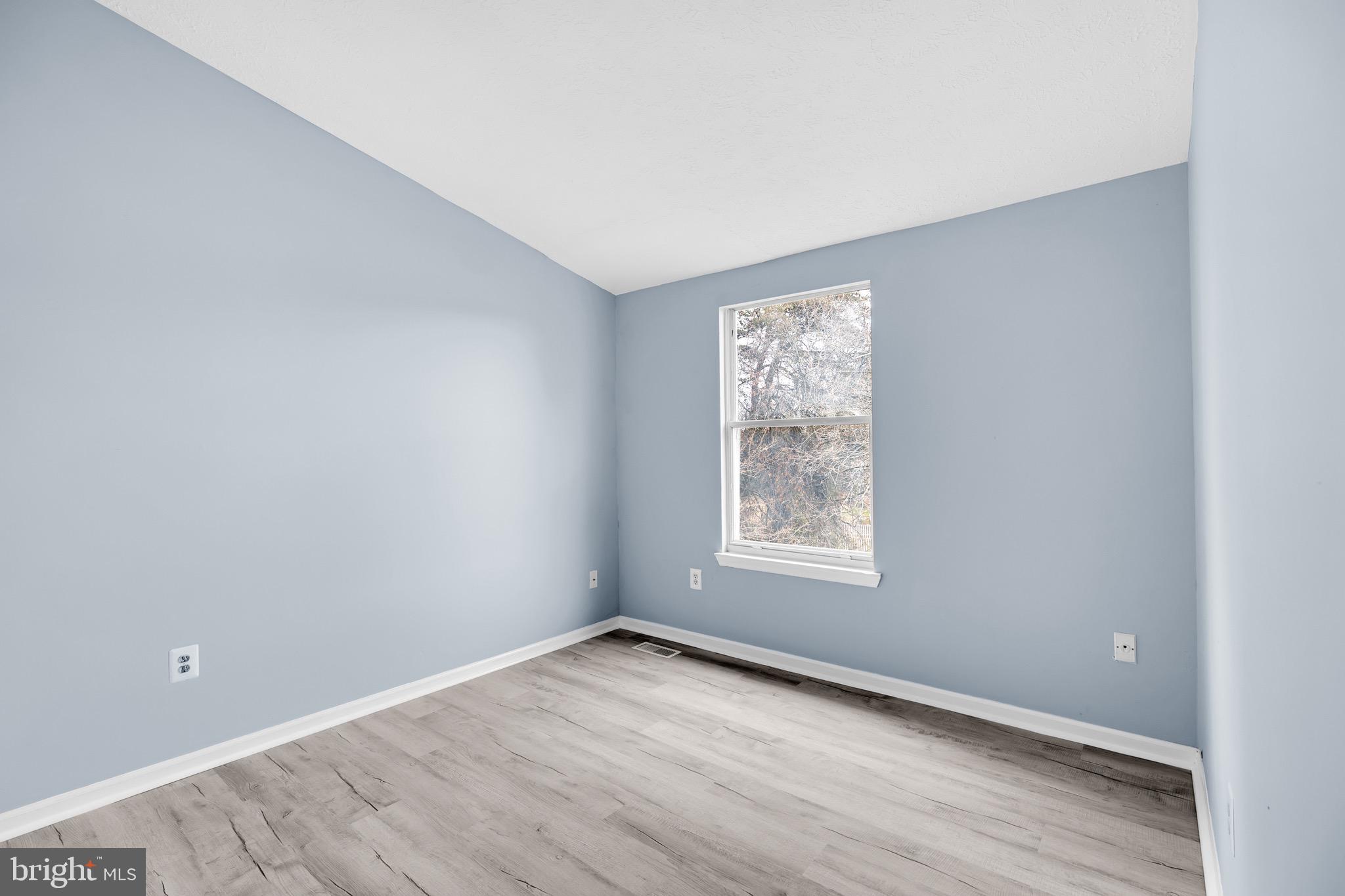 7600 Mandan Road Greenbelt, MD 20770 - Photo 28 of 42 an empty room with wooden floor and windows
