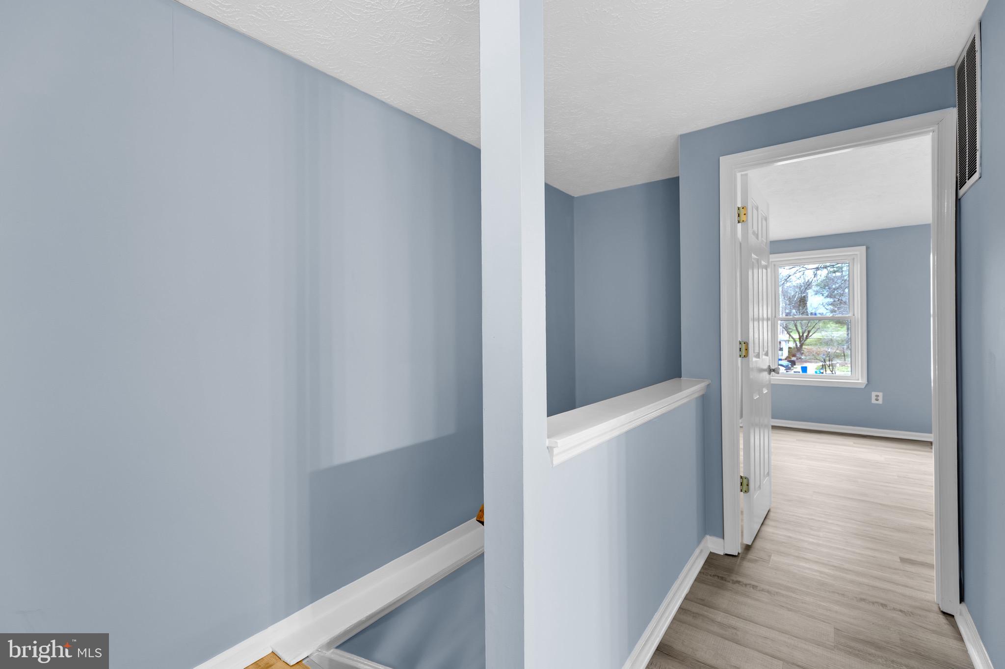 7600 Mandan Road Greenbelt, MD 20770 - Photo 31 of 42 a view of a hallway with wooden floor