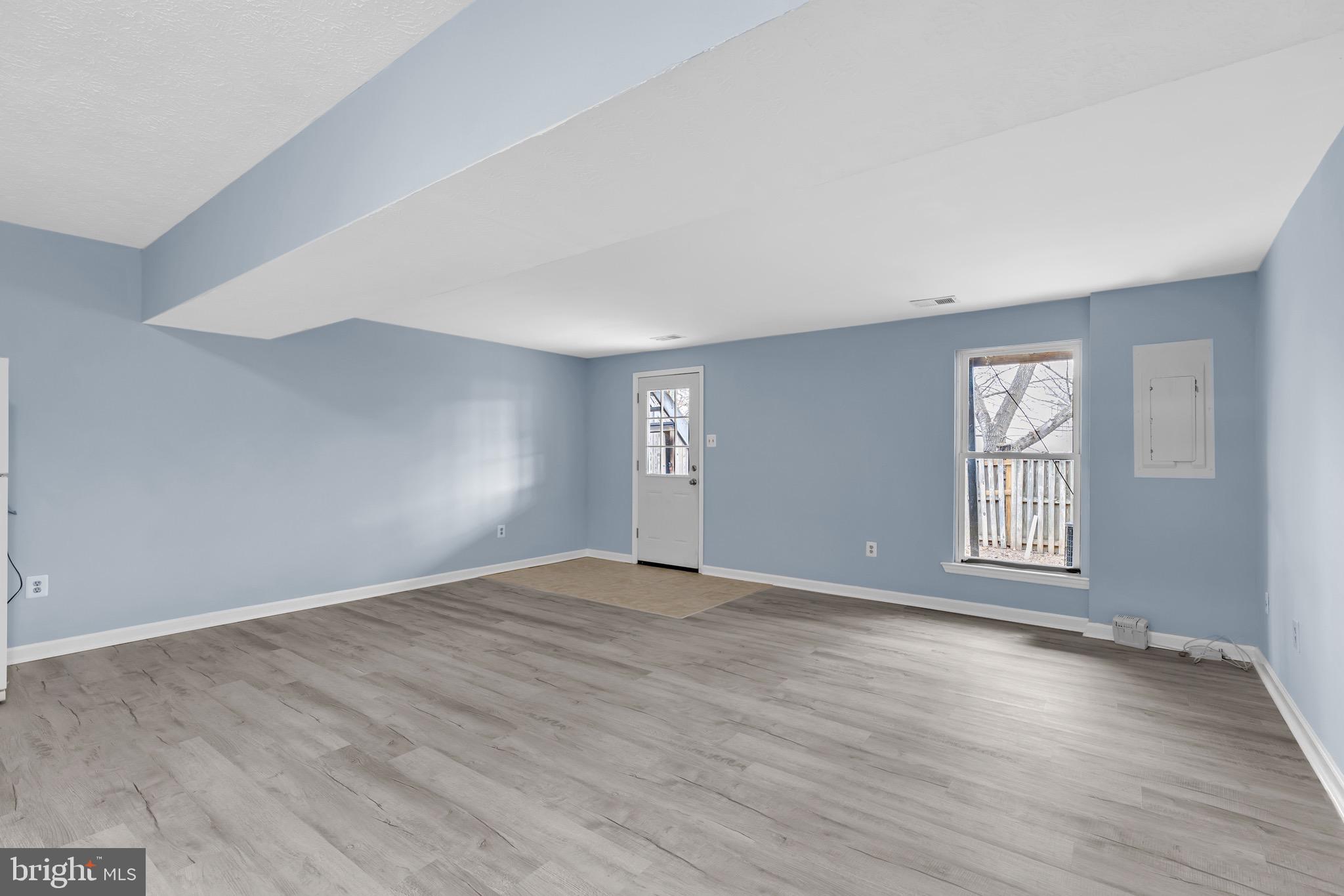 7600 Mandan Road Greenbelt, MD 20770 - Photo 32 of 42 a view of an empty room with wooden floor and window