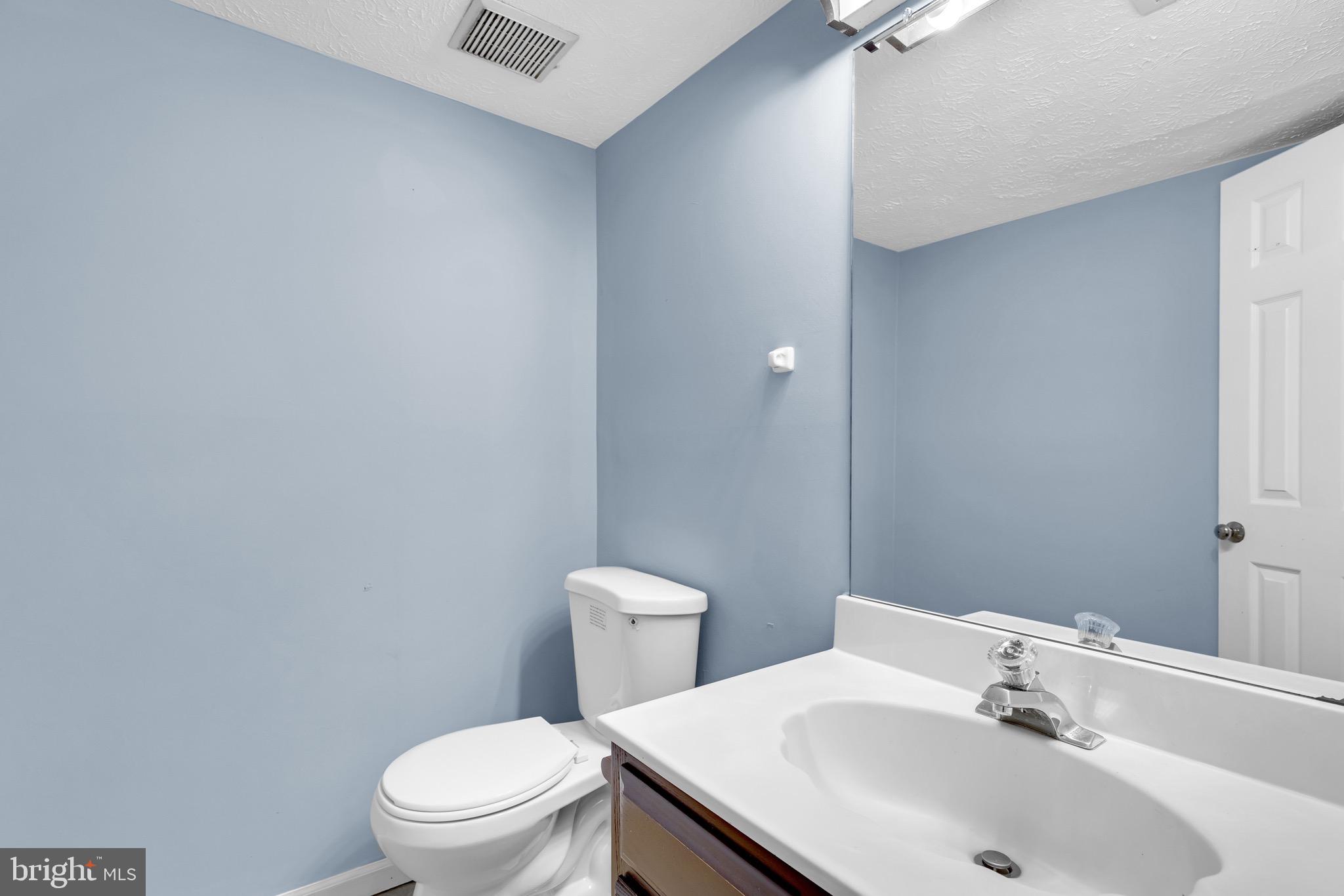 7600 Mandan Road Greenbelt, MD 20770 - Photo 34 of 42 a bathroom with a sink toilet and a mirror