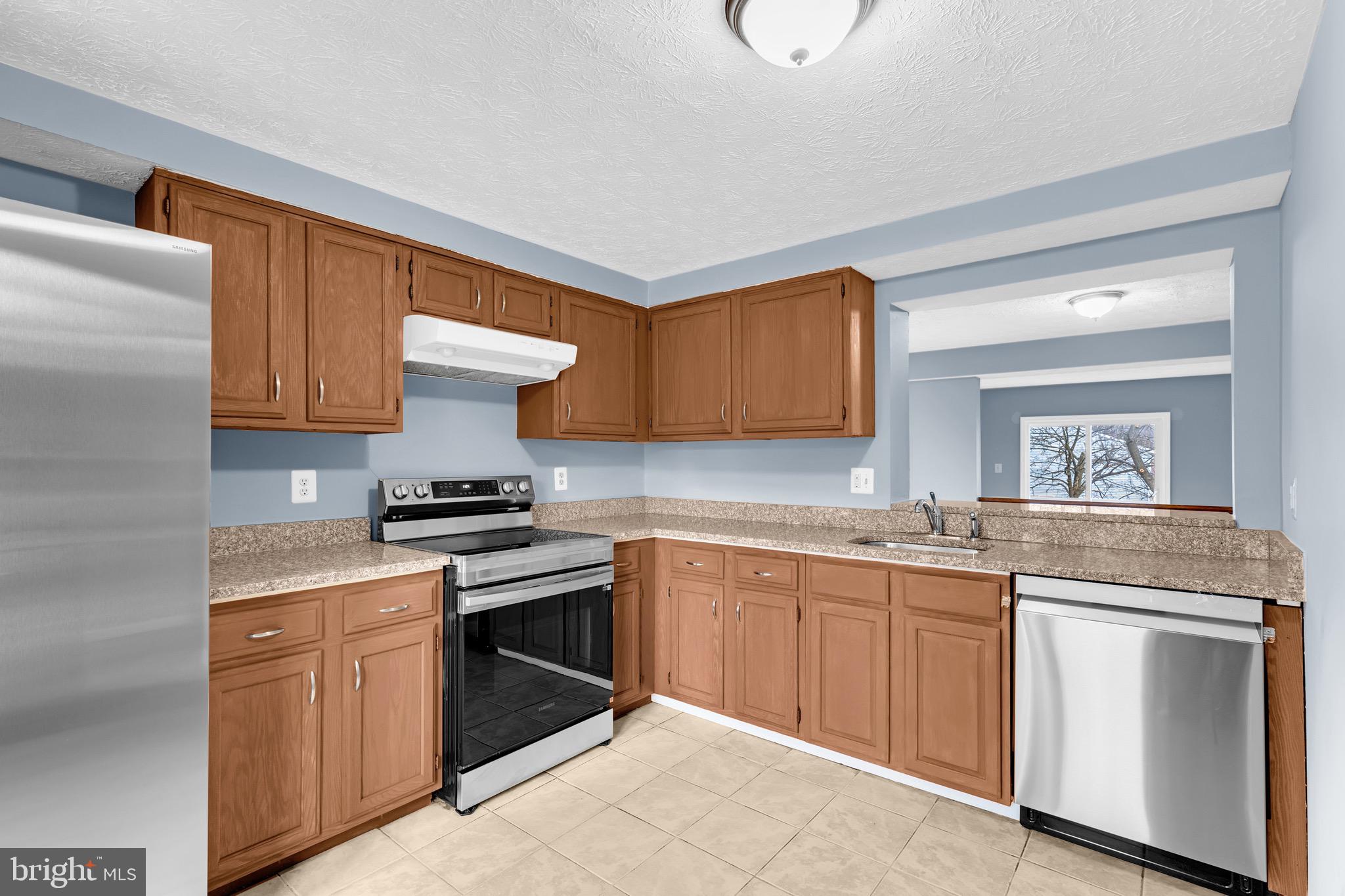 7600 Mandan Road Greenbelt, MD 20770 - Photo 7 of 42 a kitchen with a sink stove and cabinets