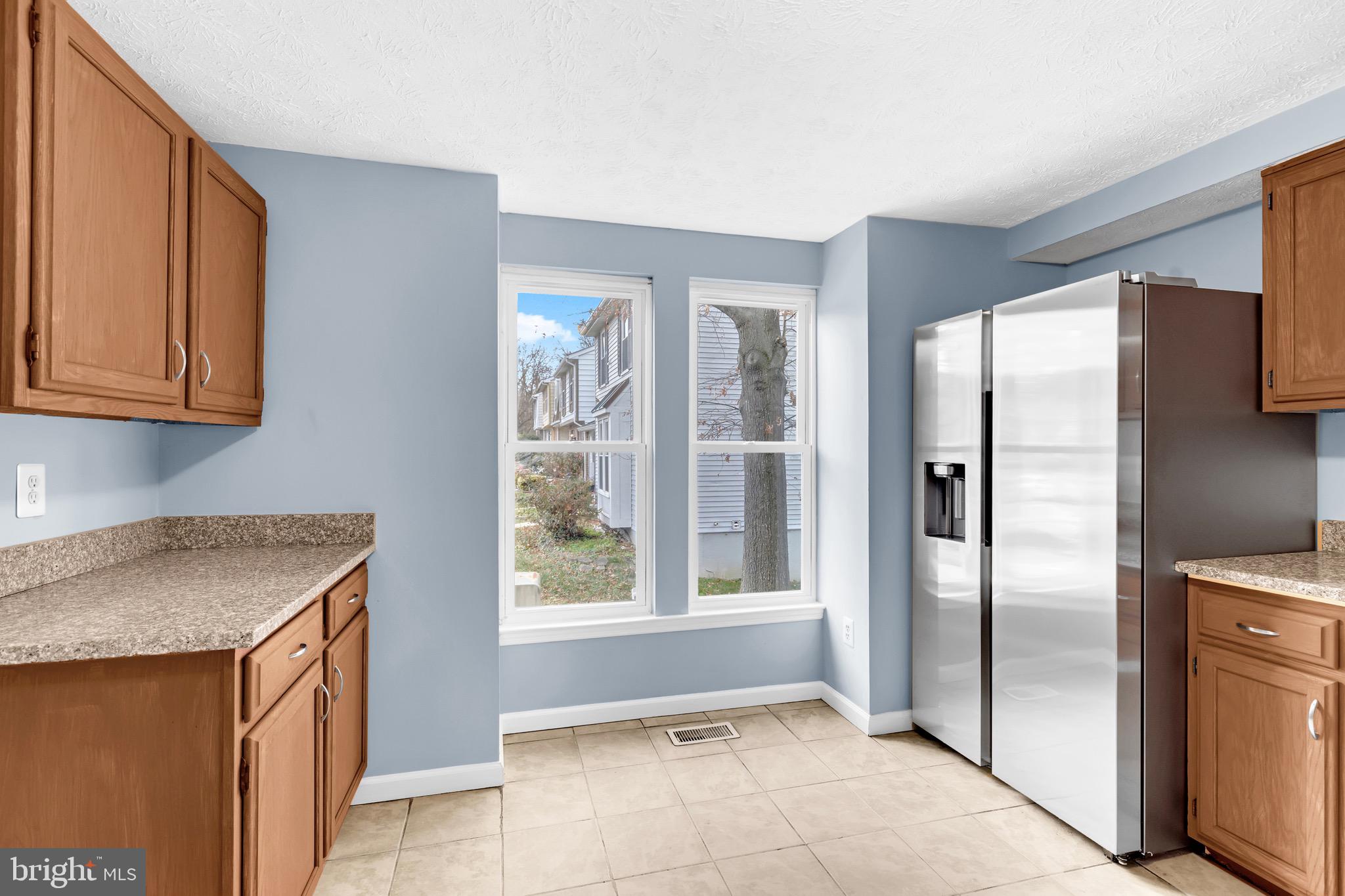 7600 Mandan Road Greenbelt, MD 20770 - Photo 9 of 42 a kitchen with stainless steel appliances granite countertop a refrigerator and a sink