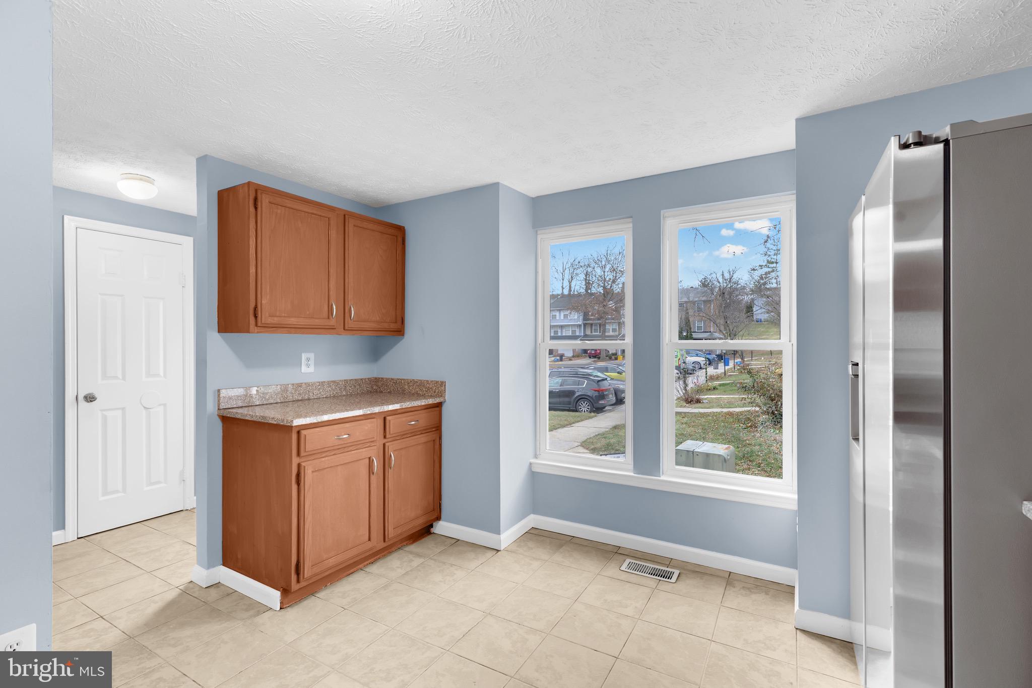 7600 Mandan Road Greenbelt, MD 20770 - Photo 10 of 42 a room with stainless steel appliances granite countertop a stove and a refrigerator