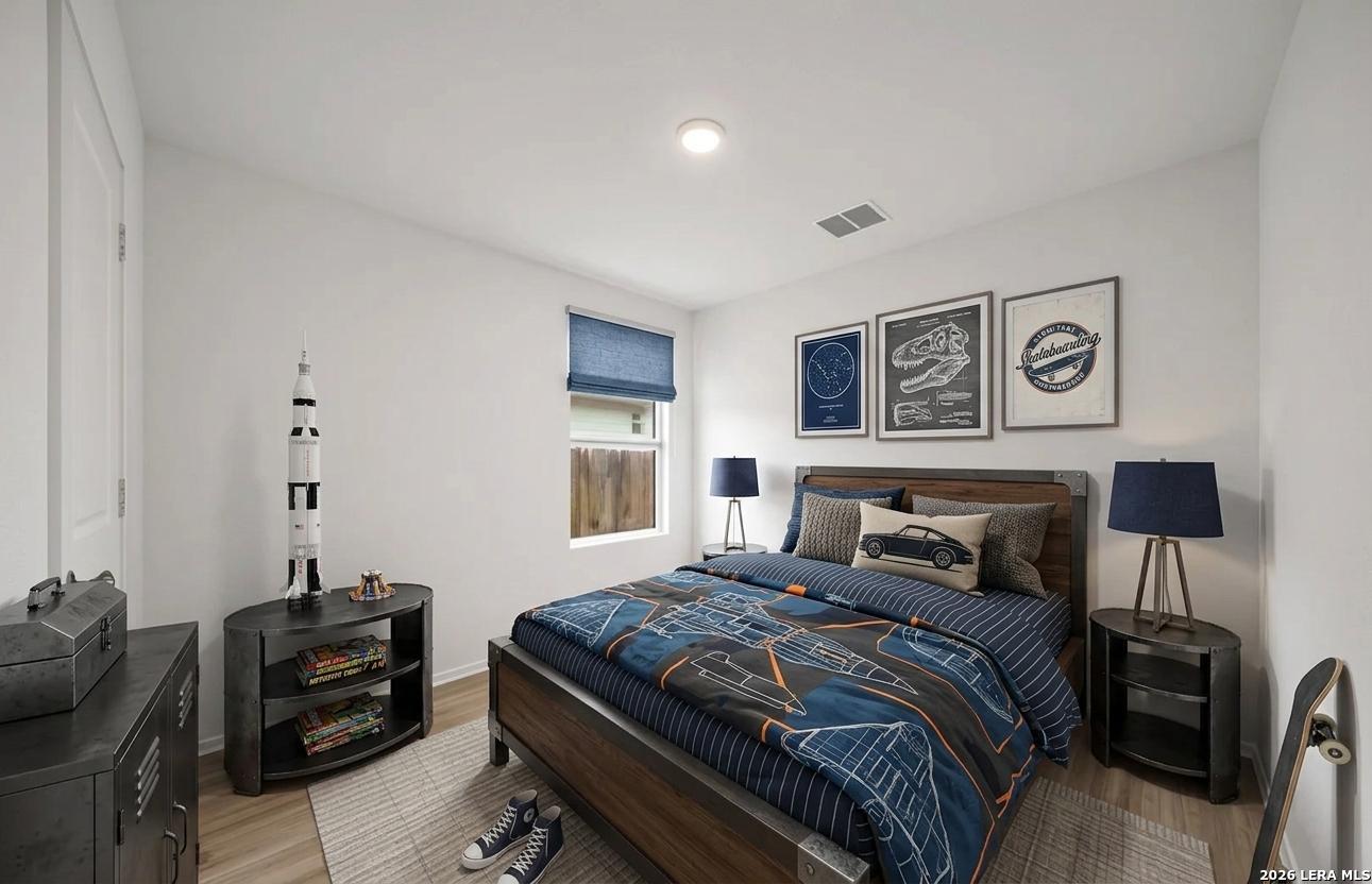 6566 Runaway Row Converse, TX 78109 - Photo 18 of 27 a bedroom with a bed and furniture