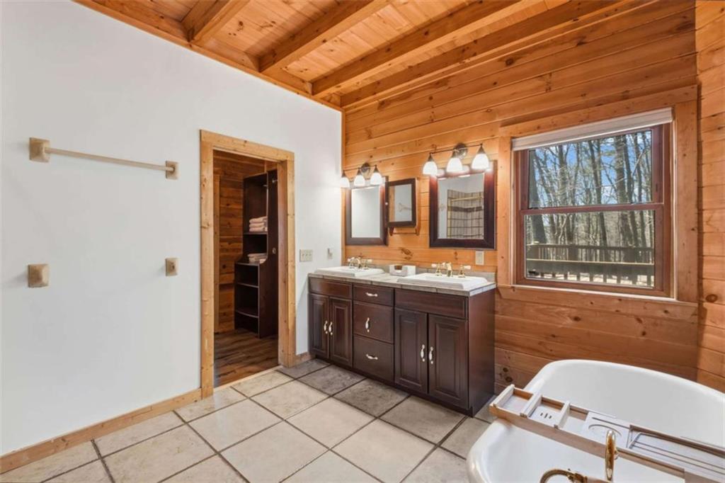 71 Cutthroat Ridge Road Jasper, GA 30143 - Photo 20 of 44 a spacious bathroom with a granite countertop sink mirror and a bathtub