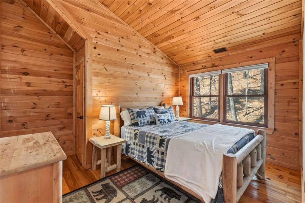 71 Cutthroat Ridge Road Jasper, GA 30143 - Photo 28 of 44 a spacious bedroom with a bed and a window