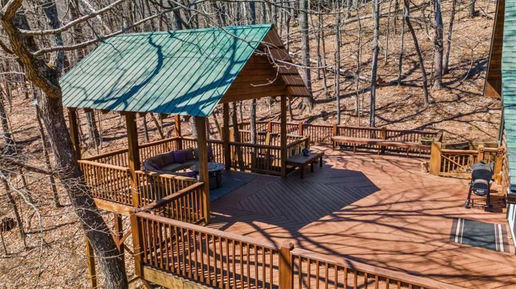 71 Cutthroat Ridge Road Jasper, GA 30143 - Photo 3 of 44 a view of a patio with table and chairs with wooden floor and fence
