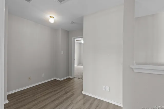 a view of a room with wooden floor